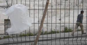 a white plastic bag caught on a wire fence