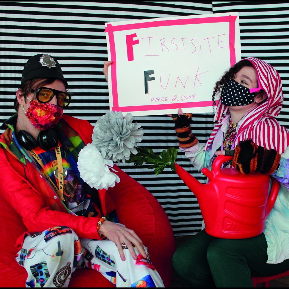 One adult one child wearing fancy dress with a black and white striped background