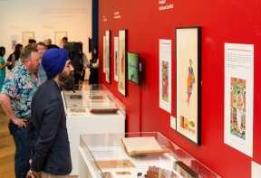 Visitors view artworks in the exhibition The Singh Twins: Slaves of Fashion, Private View at Firstsite, 2022. Photograph by Jayne Lloyd