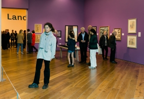 People stand in groups in the Denis Wirth Miller, Landscapes and Beasts Exhibition at Firstsite 2022.