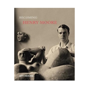 Henry Moore posing with one of his reclining figure sculptures.