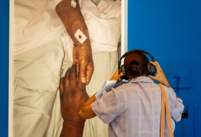 A person wearing headphones, listening to the recording as part of EVEWRIGHT'S 'Mother's Touch' artwork.