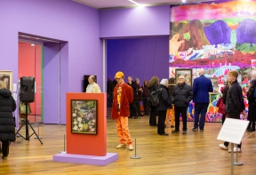 Visitors looking at artworks in the Lucy Harwood exhibition Bold Impressions at Firstsite.