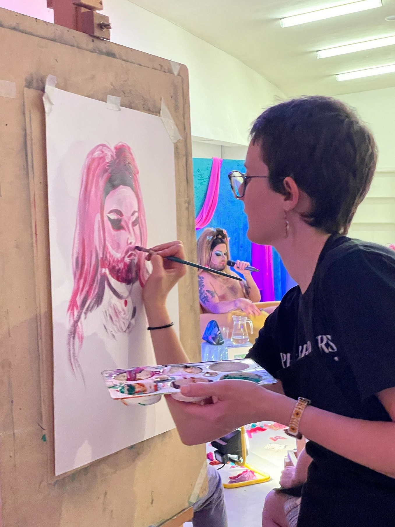 A person at Drag Life Drawing paints Sirena Hart