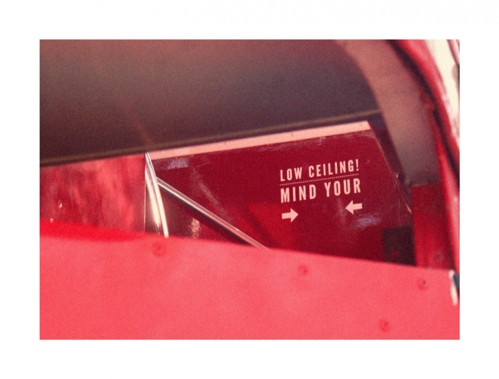 red walls and a sign that reads 'low ceiling mind your head'