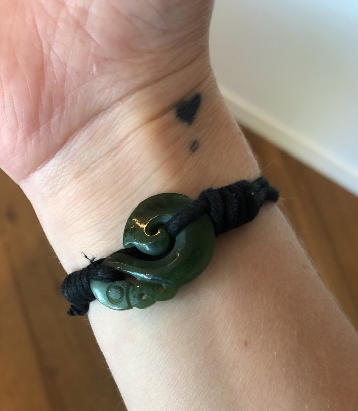 a wrist with a jade maori bracelet