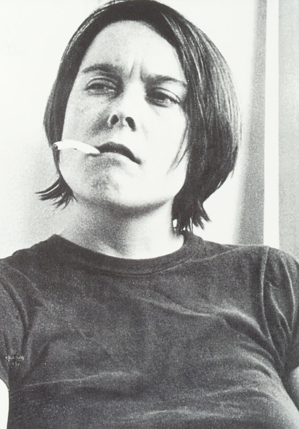 artist Sarah Lucas smoking a cigarette with long ash
