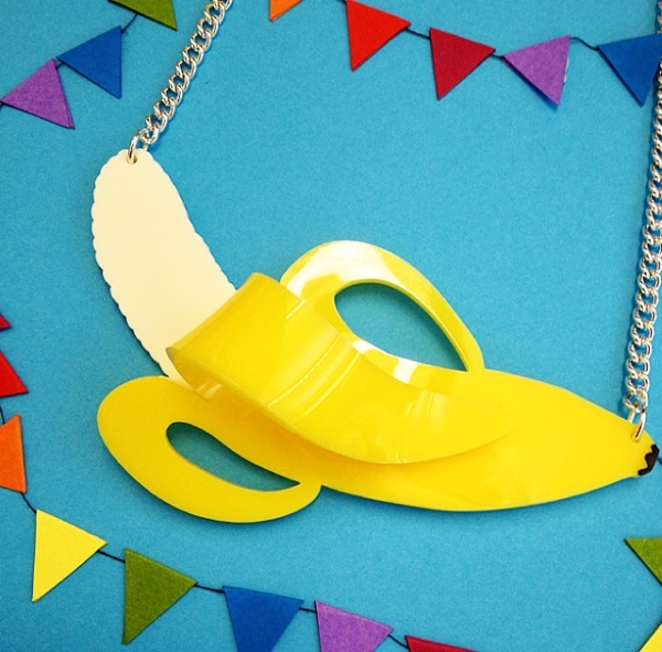 Tatty Devine Banana Necklace on blue background