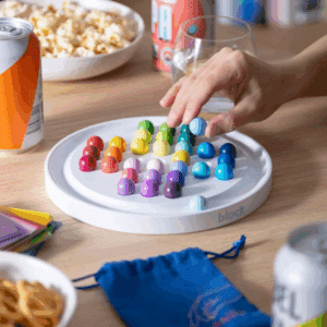 An image showing a hand interacting with the colourful solitaire set.