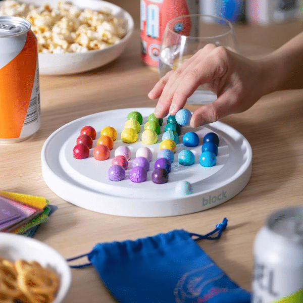 An image showing a hand interacting with the colourful solitaire set.